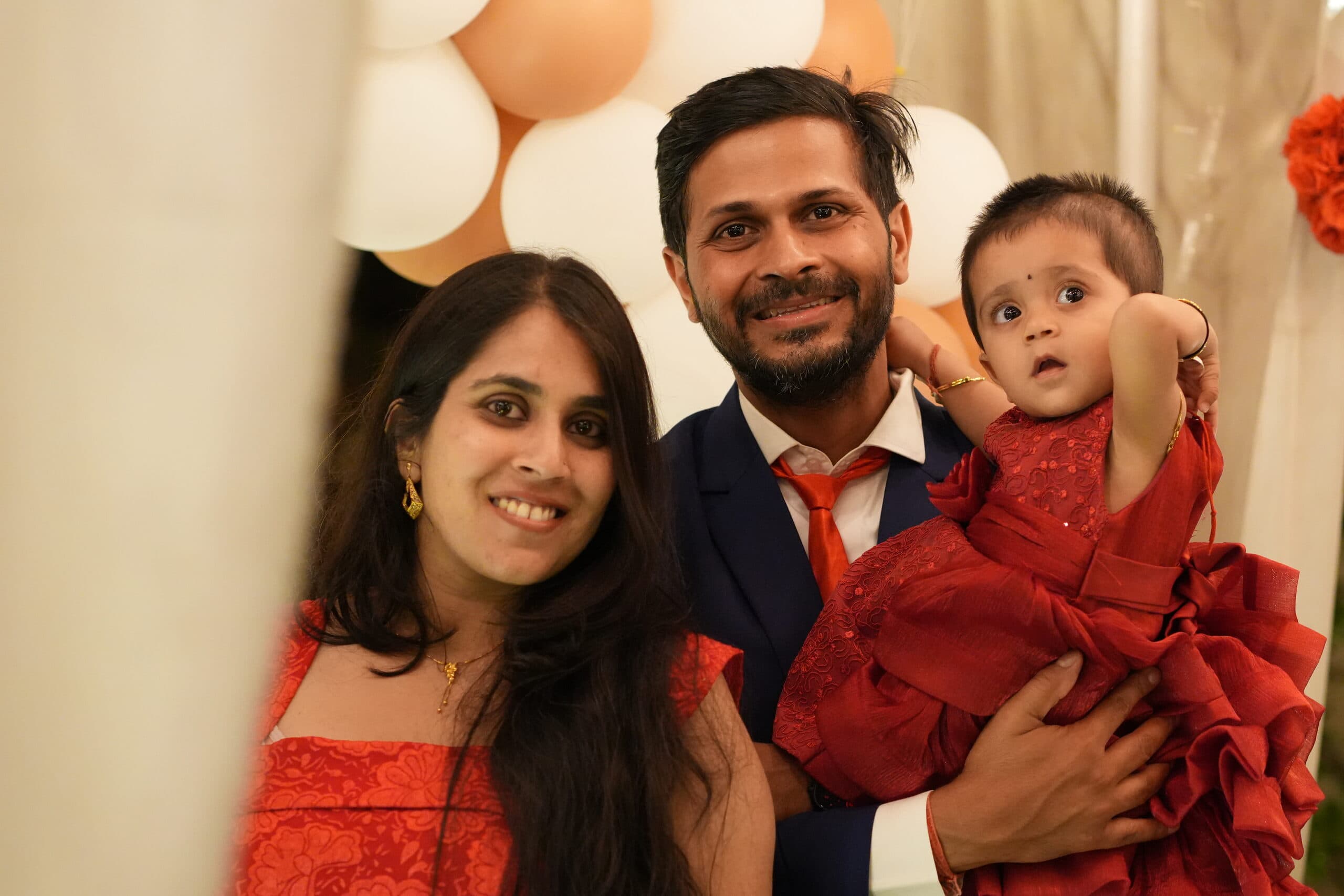 Parents holding their daughter at her first birthday